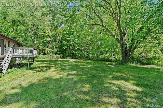 13041 Big Lake Rd, Davisburg, MI 48350 - view of yard with a wooden deck, stairs, and a wooded view