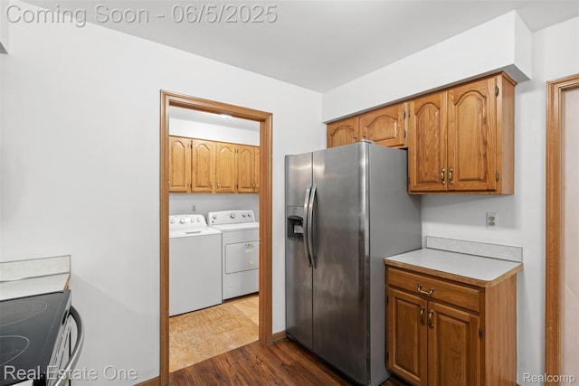 2343 Heritage Pointe Dr Unit 29, Sterling Heights, MI 48314 - kitchen featuring washer and clothes dryer, appliances with stainless steel finishes, dark wood-style flooring, brown cabinets, and light countertops