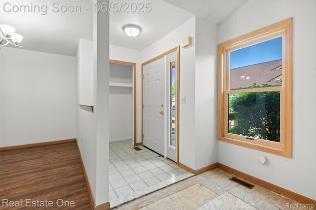 2343 Heritage Pointe Dr Unit 29, Sterling Heights, MI 48314 - entryway featuring baseboards and a chandelier
