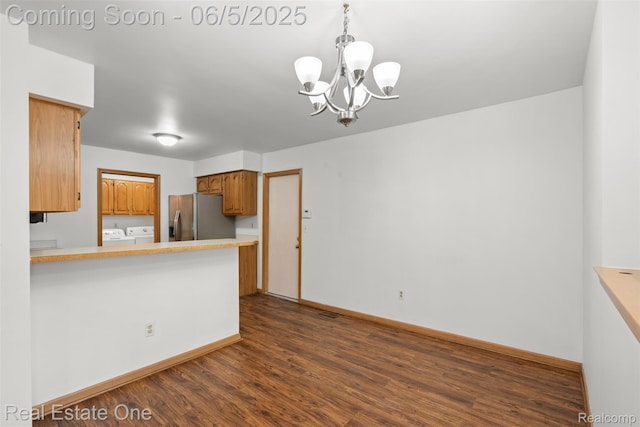 2343 Heritage Pointe Dr Unit 29, Sterling Heights, MI 48314 - kitchen featuring stainless steel fridge, a chandelier, dark wood-style flooring, baseboards, and brown cabinets