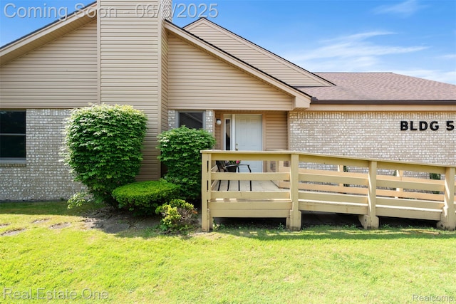 2343 Heritage Pointe Dr Unit 29, Sterling Heights, MI 48314 - back of property with a yard, brick siding, and a deck