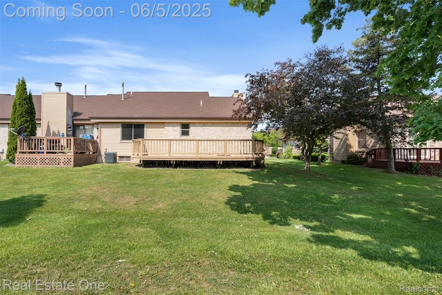 2343 Heritage Pointe Dr Unit 29, Sterling Heights, MI 48314 - view of grassy yard featuring a wooden deck and central AC unit
