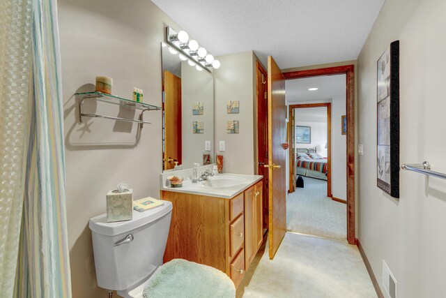 3547 Sand Bar Ct, Muskegon, MI 49441 - full bathroom with vanity, connected bathroom, toilet, and a textured ceiling
