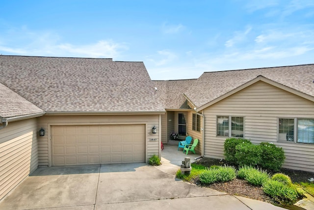 3547 Sand Bar Ct, Muskegon, MI 49441 - view of front of property with concrete driveway, an attached garage, and roof with shingles