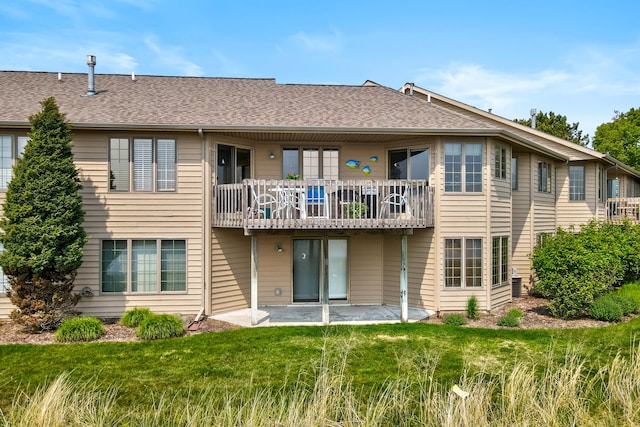 3547 Sand Bar Ct, Muskegon, MI 49441 - back of property featuring a patio area, a lawn, a shingled roof, and a balcony