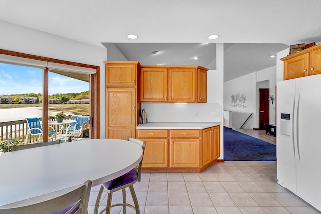 3547 Sand Bar Ct, Muskegon, MI 49441 - kitchen with white fridge with ice dispenser, light countertops, recessed lighting, and light tile patterned flooring