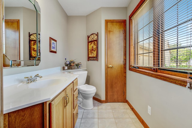 3547 Sand Bar Ct, Muskegon, MI 49441 - bathroom with vanity, toilet, tile patterned flooring, and baseboards