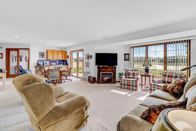 3547 Sand Bar Ct, Muskegon, MI 49441 - living area featuring light colored carpet, a glass covered fireplace, and recessed lighting