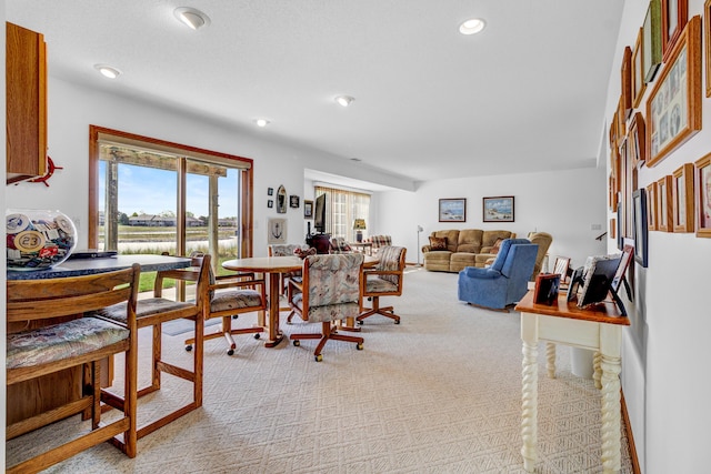 3547 Sand Bar Ct, Muskegon, MI 49441 - dining space featuring plenty of natural light, light colored carpet, a water view, and recessed lighting