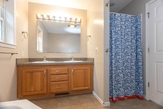18735 Jefferson Rd, Morley, MI 49336 - bathroom featuring double vanity, tile patterned flooring, baseboards, and curtained shower
