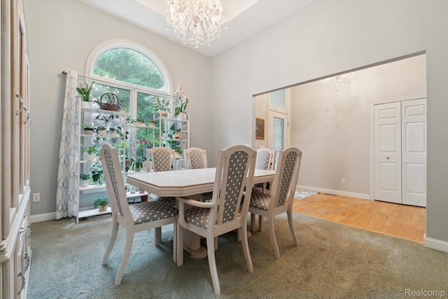 8883 Dixie Hwy, Birch Run, MI 48415 - dining room with carpet flooring, a chandelier, and a towering ceiling