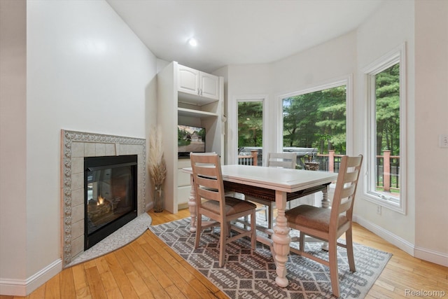 8883 Dixie Hwy, Birch Run, MI 48415 - dining space with a fireplace, healthy amount of natural light, and light wood finished floors
