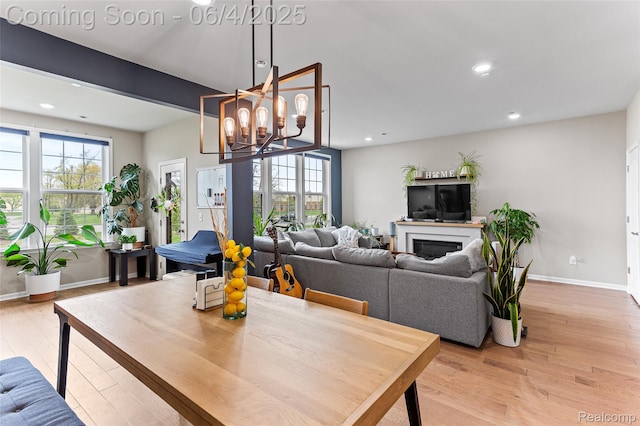 1675 Addison Cir, Walled Lake, MI 48390 - dining room featuring light wood-style flooring, recessed lighting, baseboards, a chandelier, and a fireplace