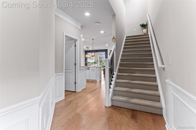 1675 Addison Cir, Walled Lake, MI 48390 - staircase featuring wood finished floors, recessed lighting, a wainscoted wall, and a decorative wall