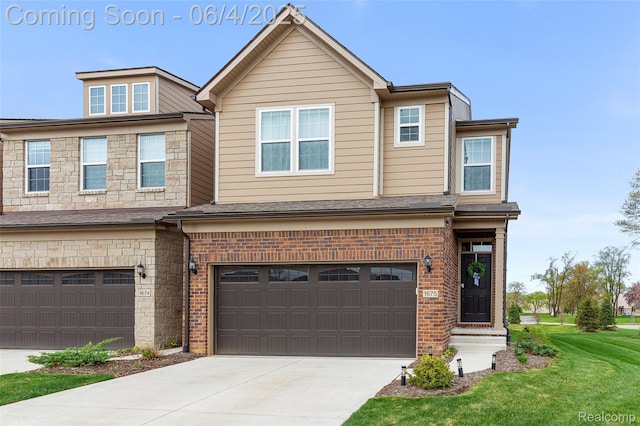 1675 Addison Cir, Walled Lake, MI 48390 - view of property featuring a garage, concrete driveway, brick siding, and a front lawn
