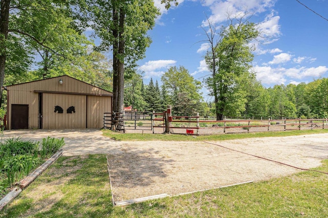 8836 Ora Lake Rd, Hale, MI 48739 - view of yard featuring a garage, an outdoor structure, dirt driveway, and a pole building