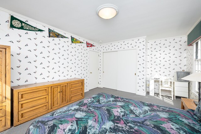 1060 Chestnut St, Ann Arbor, MI 48104 - carpeted bedroom featuring ornamental molding, wallpapered walls, and a closet