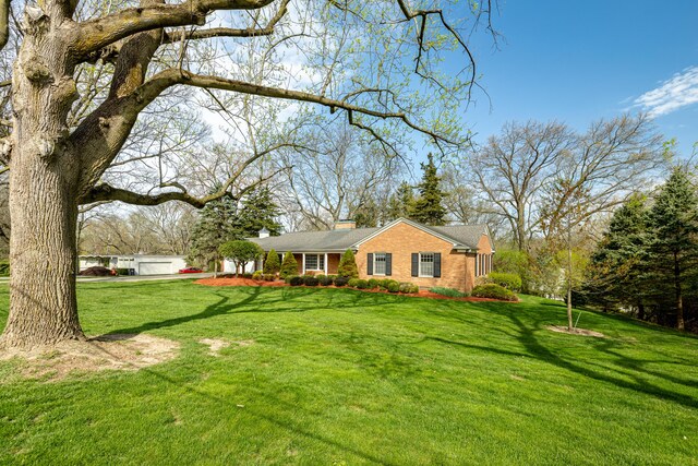 1060 Chestnut St, Ann Arbor, MI 48104 - view of front of house with brick siding, a front yard, and a chimney