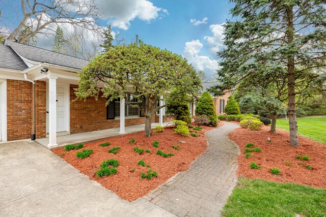 1060 Chestnut St, Ann Arbor, MI 48104 - view of front facade featuring brick siding, covered porch, and a shingled roof
