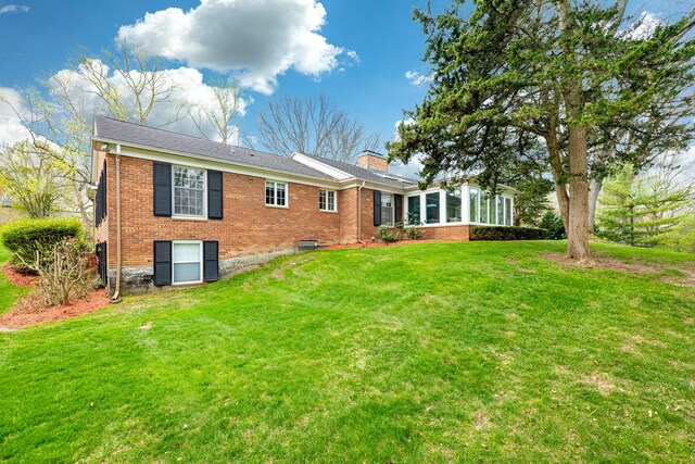 1060 Chestnut St, Ann Arbor, MI 48104 - back of property featuring a chimney, a lawn, and brick siding