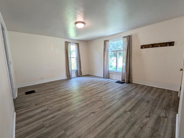 112 Howard St, Gobles, MI 49055 - empty room featuring healthy amount of natural light, wood finished floors, and baseboards