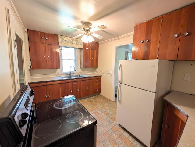 112 Howard St, Gobles, MI 49055 - kitchen with a sink, freestanding refrigerator, electric range oven, brown cabinets, and ceiling fan