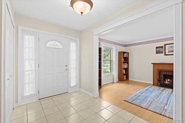 7672 Admiralty Dr, Canton, MI 48187 - entrance foyer featuring light tile patterned floors, baseboards, and a brick fireplace
