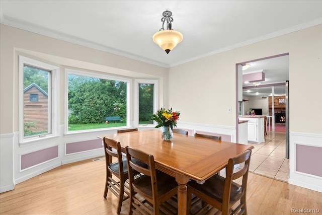 7672 Admiralty Dr, Canton, MI 48187 - dining area featuring ornamental molding, light wood-style floors, and a wainscoted wall