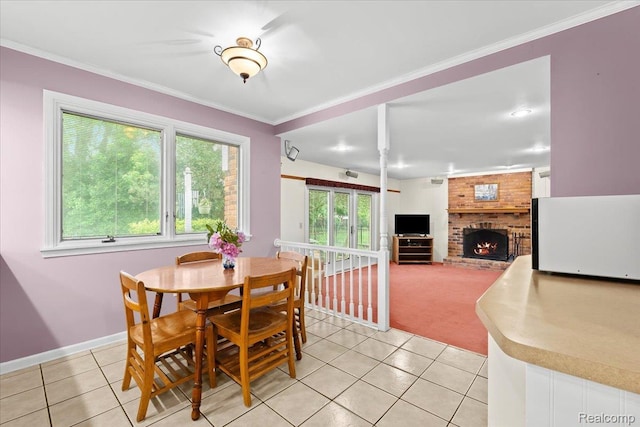 7672 Admiralty Dr, Canton, MI 48187 - dining room with light tile patterned flooring, a brick fireplace, ornamental molding, baseboards, and light carpet