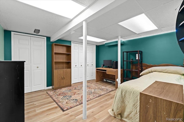 7672 Admiralty Dr, Canton, MI 48187 - bedroom featuring wood finished floors, two closets, an office area, and a drop ceiling