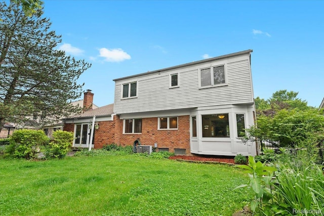 7672 Admiralty Dr, Canton, MI 48187 - back of property featuring a chimney, brick siding, and a lawn