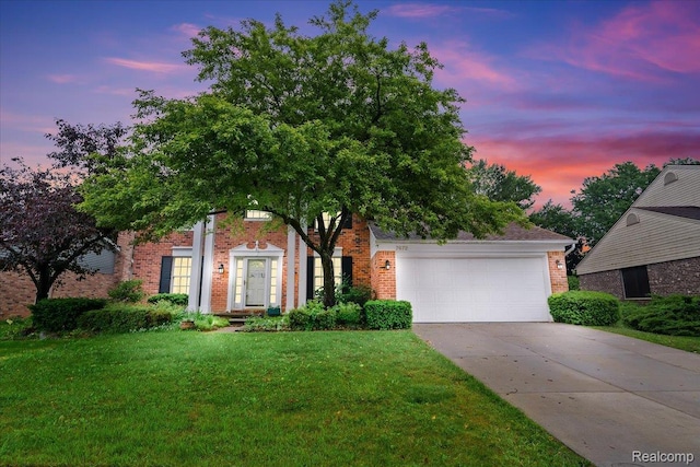7672 Admiralty Dr, Canton, MI 48187 - view of front of home with brick siding, driveway, a front yard, and an attached garage