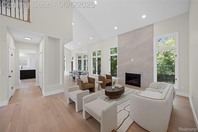 4610 Woodbine Cir W, Bloomfield, MI 48323 - living area with light wood-type flooring, healthy amount of natural light, baseboards, a tile fireplace, and recessed lighting