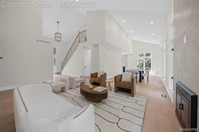 4610 Woodbine Cir W, Bloomfield, MI 48323 - living room featuring light wood-type flooring, high vaulted ceiling, stairs, baseboards, and recessed lighting
