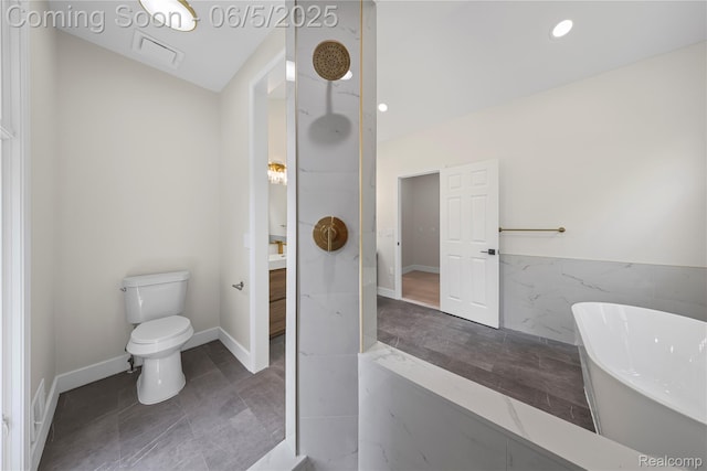 4610 Woodbine Cir W, Bloomfield, MI 48323 - bathroom featuring a freestanding bath, toilet, and tile walls