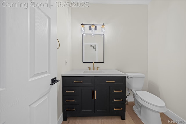 4610 Woodbine Cir W, Bloomfield, MI 48323 - bathroom with toilet, baseboards, vanity, and wood finished floors