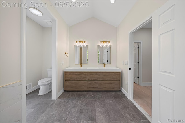 4610 Woodbine Cir W, Bloomfield, MI 48323 - full bath with double vanity, vaulted ceiling, toilet, and baseboards