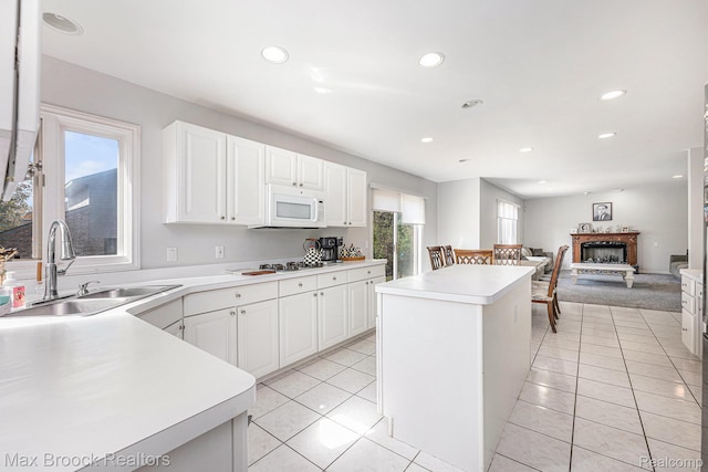 6011 Maple Frst, West Bloomfield, MI 48322 - kitchen featuring a sink, white appliances, a kitchen island, light countertops, and white cabinets