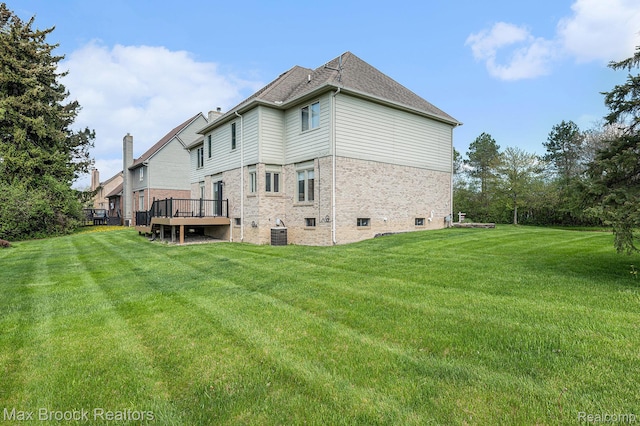 6011 Maple Frst, West Bloomfield, MI 48322 - back of house with a yard, central AC unit, brick siding, and a deck