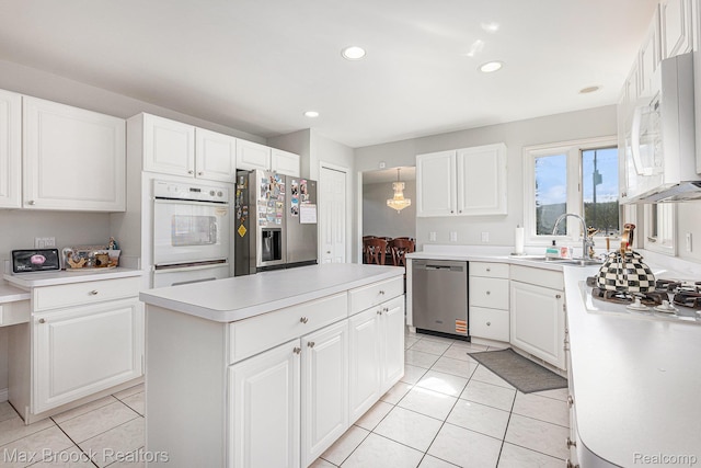 6011 Maple Frst, West Bloomfield, MI 48322 - kitchen with stainless steel appliances, a sink, a center island, light countertops, and light tile patterned floors