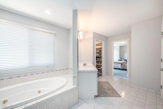 6011 Maple Frst, West Bloomfield, MI 48322 - bathroom with a jetted tub, a walk in closet, tile patterned floors, connected bathroom, and vanity