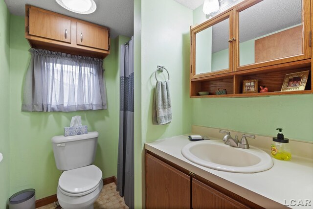 8400 Horton Beach Dr, Manitou Beach, MI 49253 - full bath featuring toilet, vanity, a textured ceiling, and baseboards