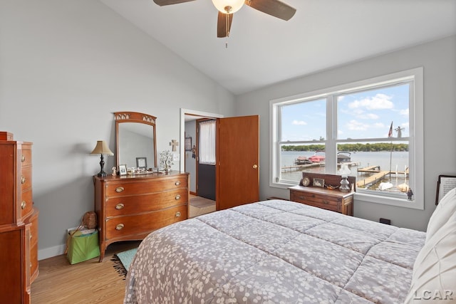 8400 Horton Beach Dr, Manitou Beach, MI 49253 - bedroom featuring light wood-style floors, vaulted ceiling, baseboards, a ceiling fan, and a water view