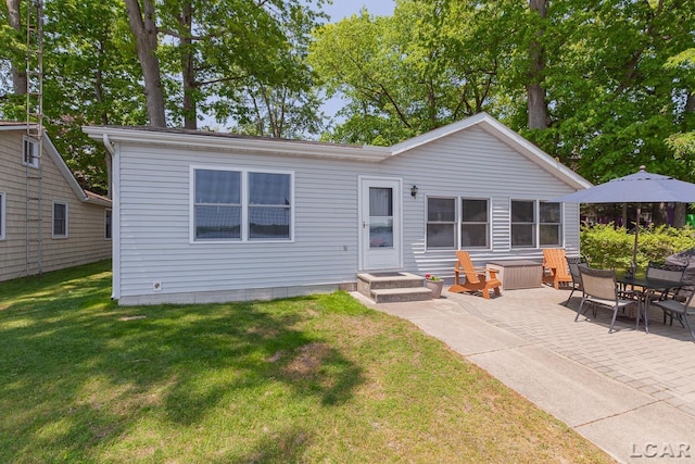 8400 Horton Beach Dr, Manitou Beach, MI 49253 - back of property with a lawn and a patio