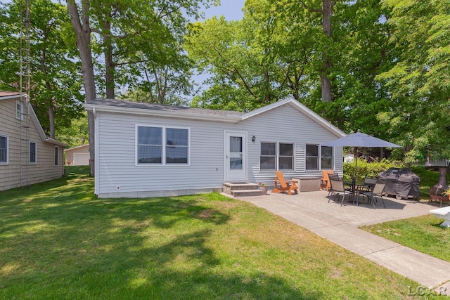 8400 Horton Beach Dr, Manitou Beach, MI 49253 - rear view of property with a yard and a patio
