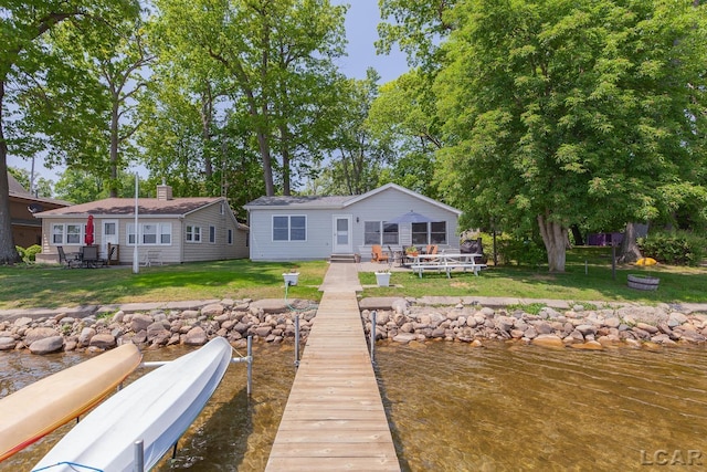 8400 Horton Beach Dr, Manitou Beach, MI 49253 - back of house featuring a yard, a water view, a patio, and entry steps
