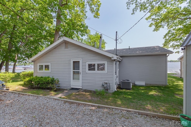8400 Horton Beach Dr, Manitou Beach, MI 49253 - rear view of property featuring a yard, central air condition unit, and roof with shingles