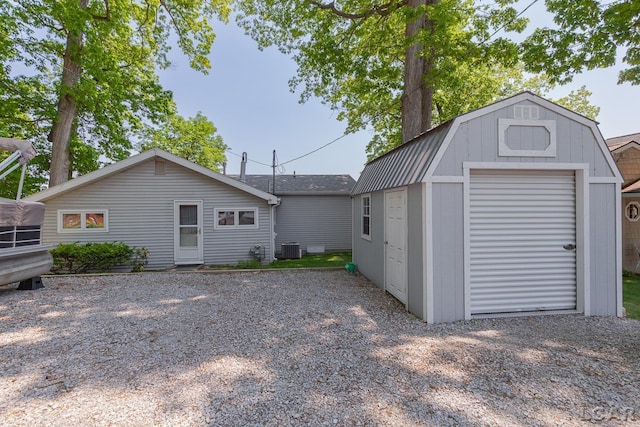 8400 Horton Beach Dr, Manitou Beach, MI 49253 - back of property featuring a gambrel roof and central AC unit