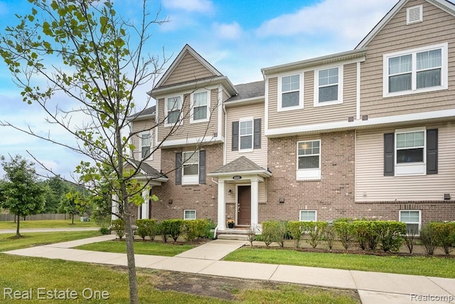 4661 Bradley Cir, Troy, MI 48085 - view of property featuring a front lawn and brick siding