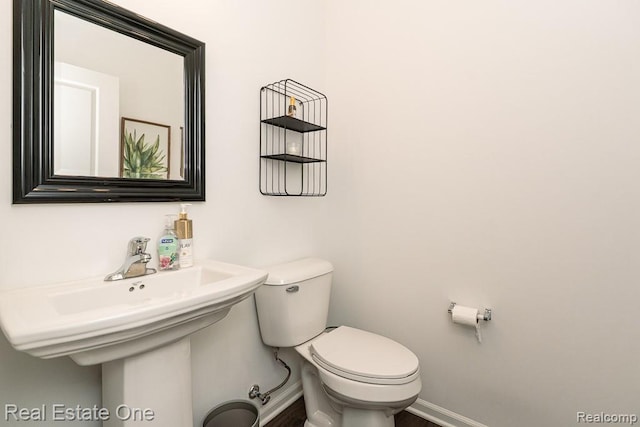4661 Bradley Cir, Troy, MI 48085 - bathroom featuring baseboards, toilet, and wood finished floors